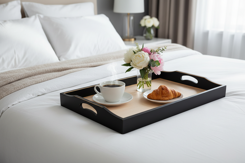 Black and gold wooden serving tray styled as breakfast in bed setup